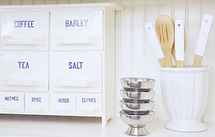 Vintage porcelain spice rack with kitchen utincels.