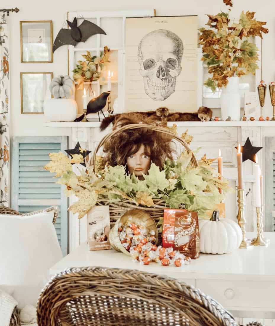 Vintage Halloween ideas using a hairdresser mannequin in a basket with foraged leaves on dining room table