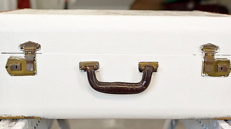 Vintage suitcase with two coats of antique white paint.