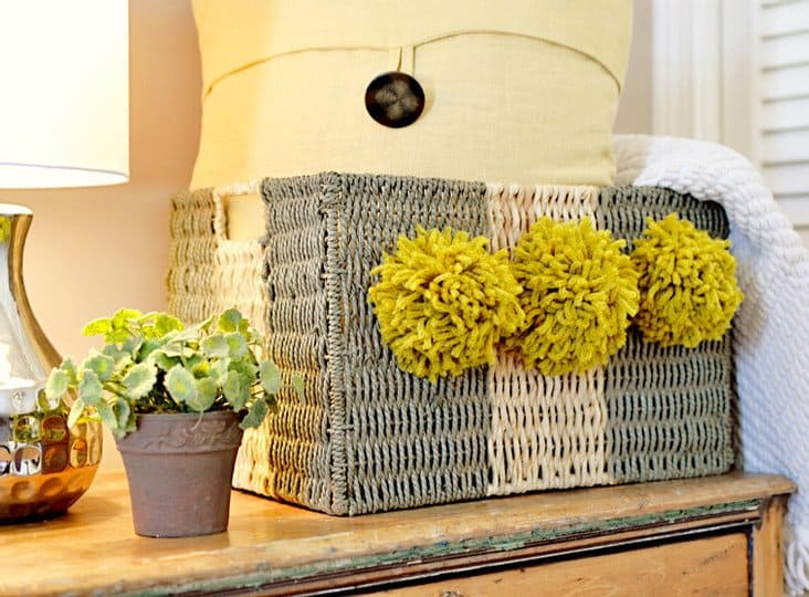 striped basket with pom poms