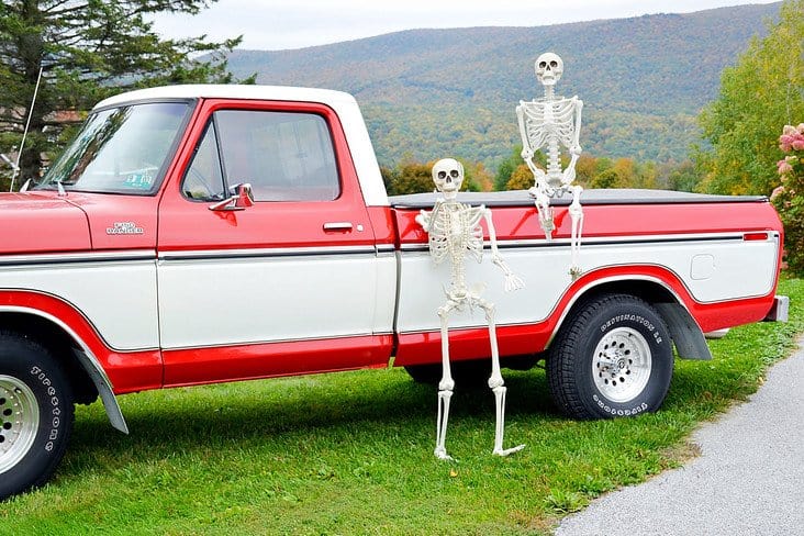 Halloween skeletons and Vintage Ford truck in the mountains.