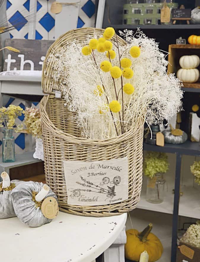 Vintage basket full of white and gold dried flowers.