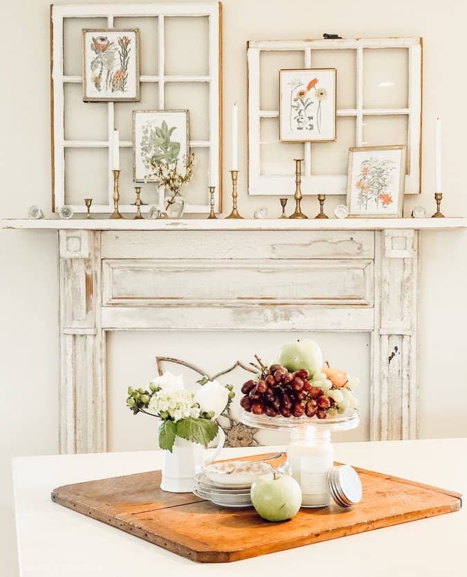 Vintage Fireplace Mantel with spring botanicals and display of fruits on dining room table.