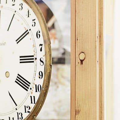 A clock sitting on top of a wooden door