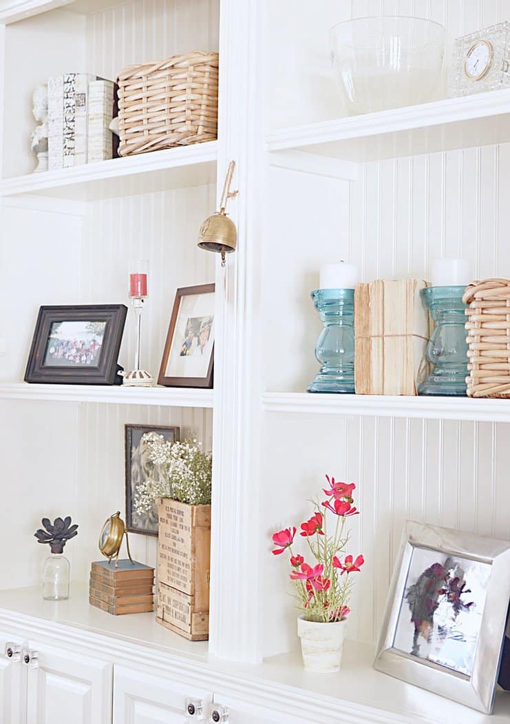 Built-Ins styled with vintage books, baskets, candles and more.