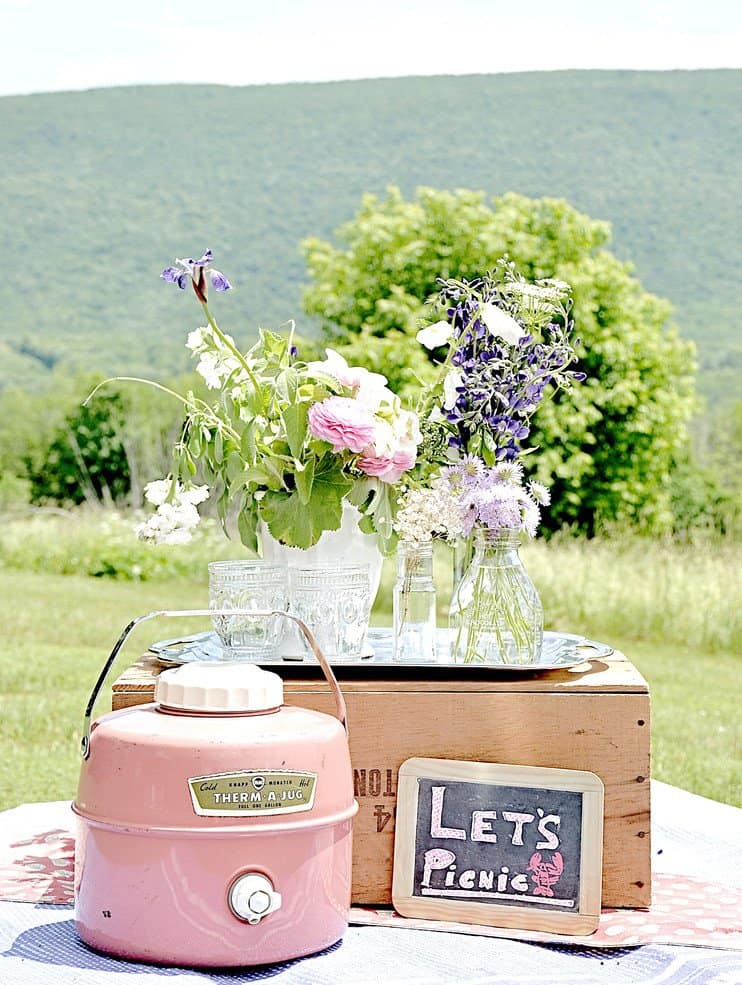 Flowers in vases, vintage jug and crate.