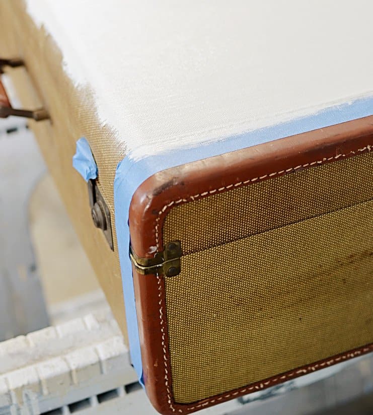 Vintage suitcase with white paint and blue painters tape