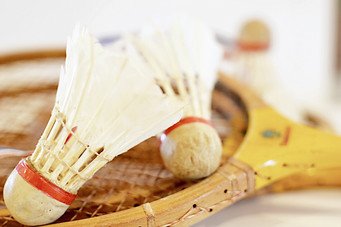 Vintage badminton birdies and racquets.