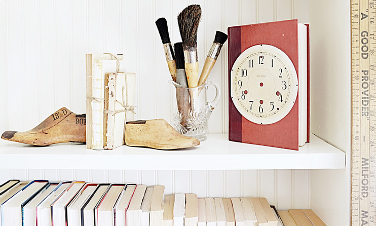 Decorated bookshelf with vintage finds.