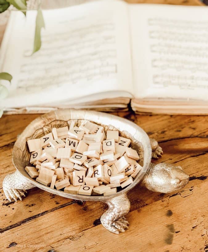 Scrabble letters in gold turtle on coffee table.