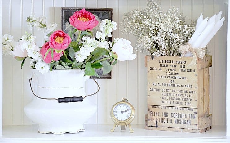 Shelfie with vintage finds and flowers.