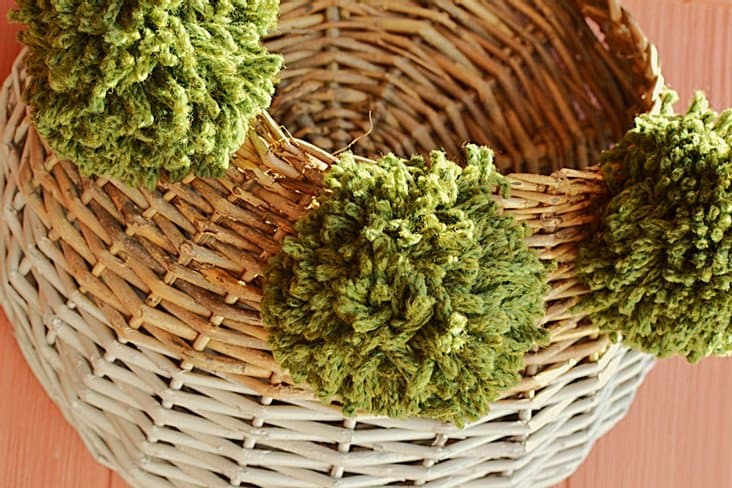 Basket with green pom poms outside