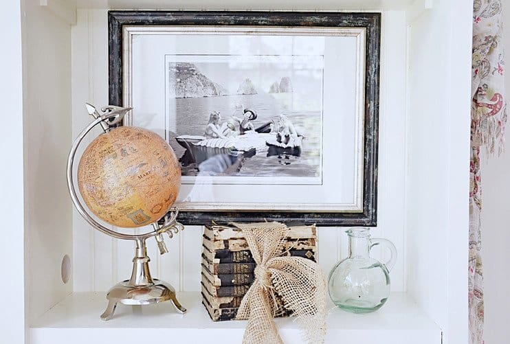 Picture hanging on shelfie wall w/ vintage style.