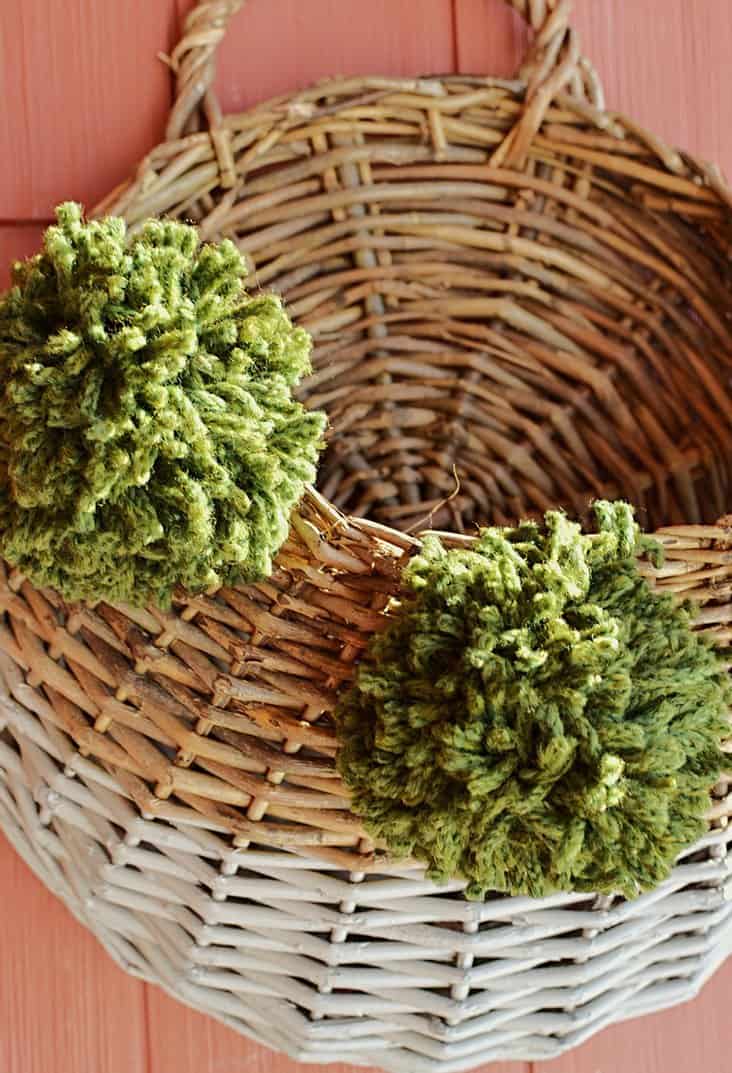 Basket with green pom poms outside