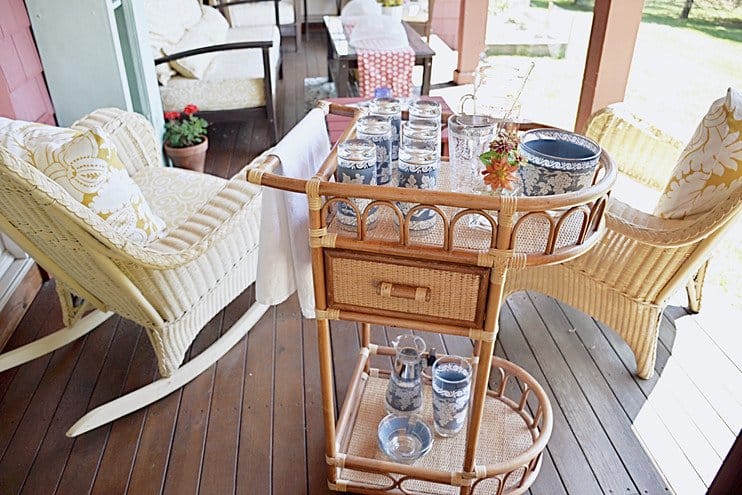 Vintage beverage cart with vintage cocktail set on the porch.