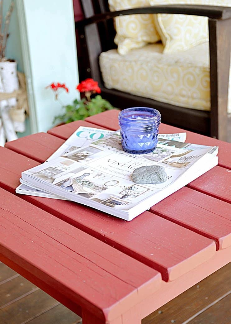 Table with magazines and candle on the porch.