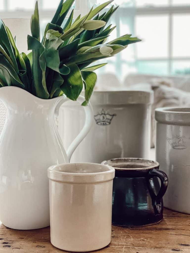 Antique Crocks and White Tulips gathered to a vintage crock flower arrangements.