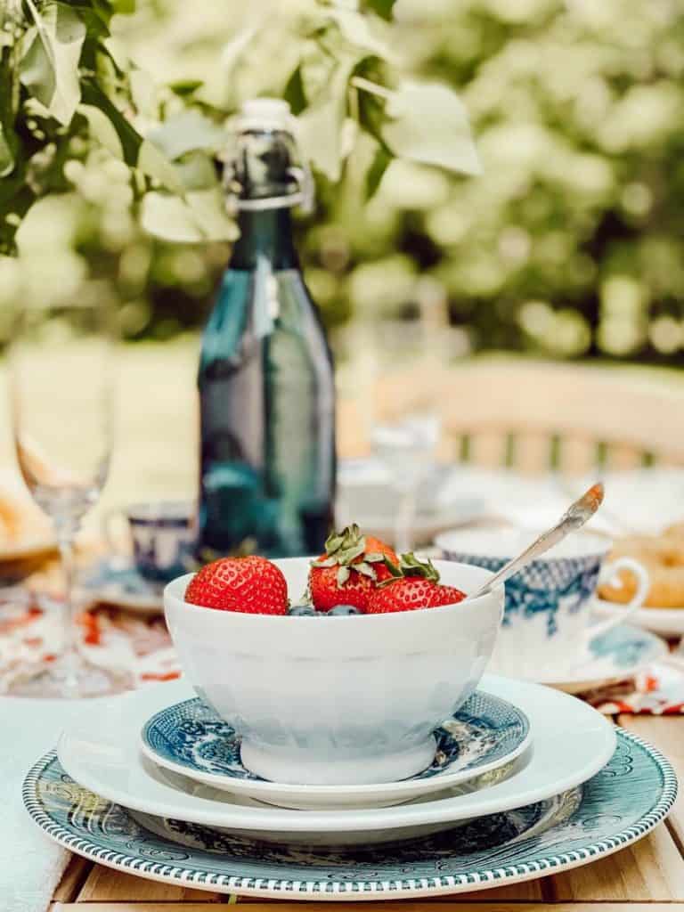 A close up of a bowl of strawberries on a table