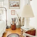 A bedroom with a bed and a chair in a room