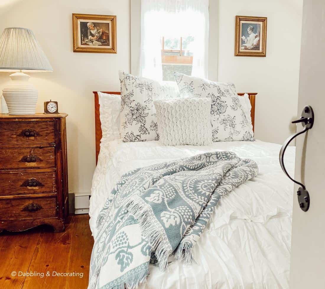 Small Attic bedroom with vintage style details and bedding.