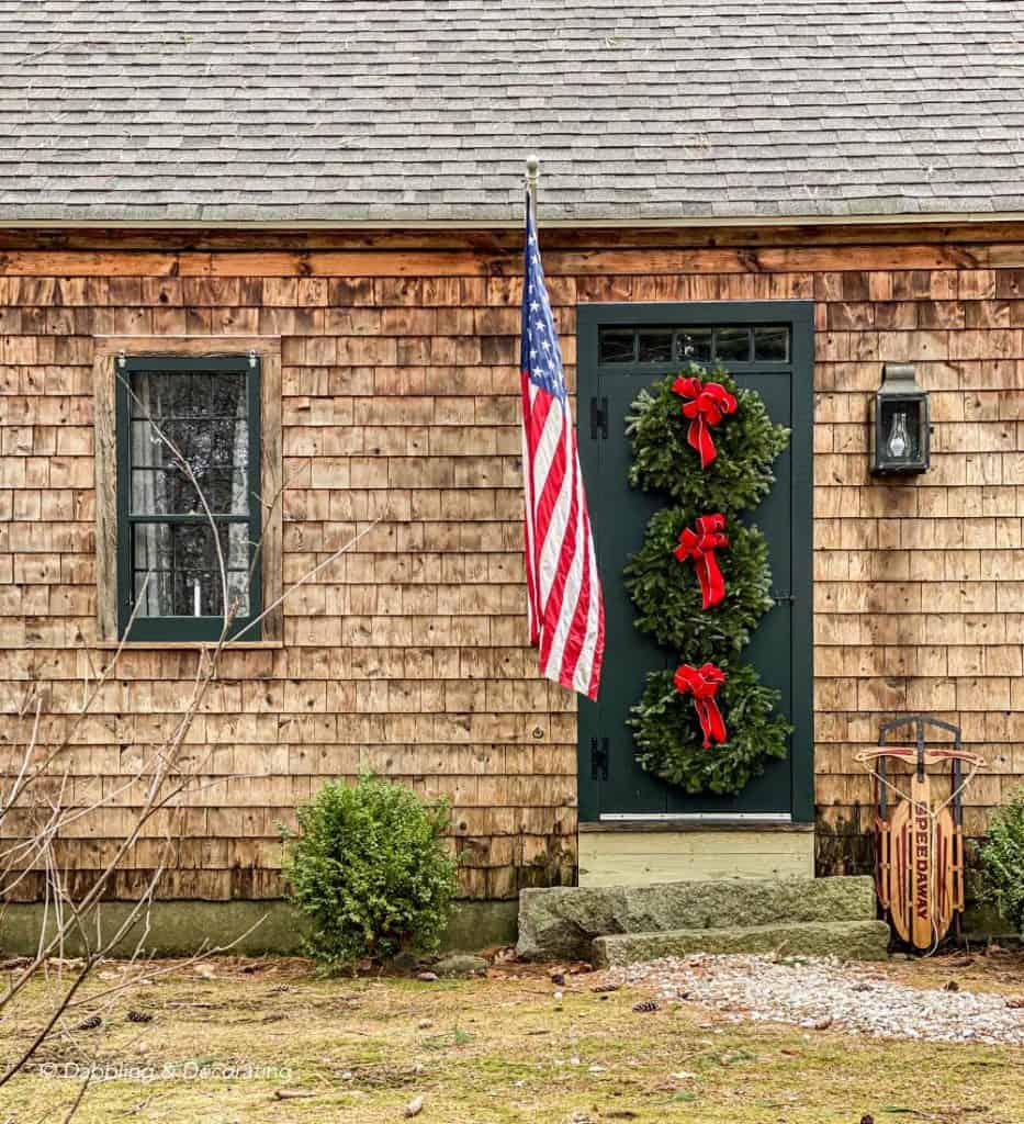 A vintage house decorated with a Christmas wreath on the front door.