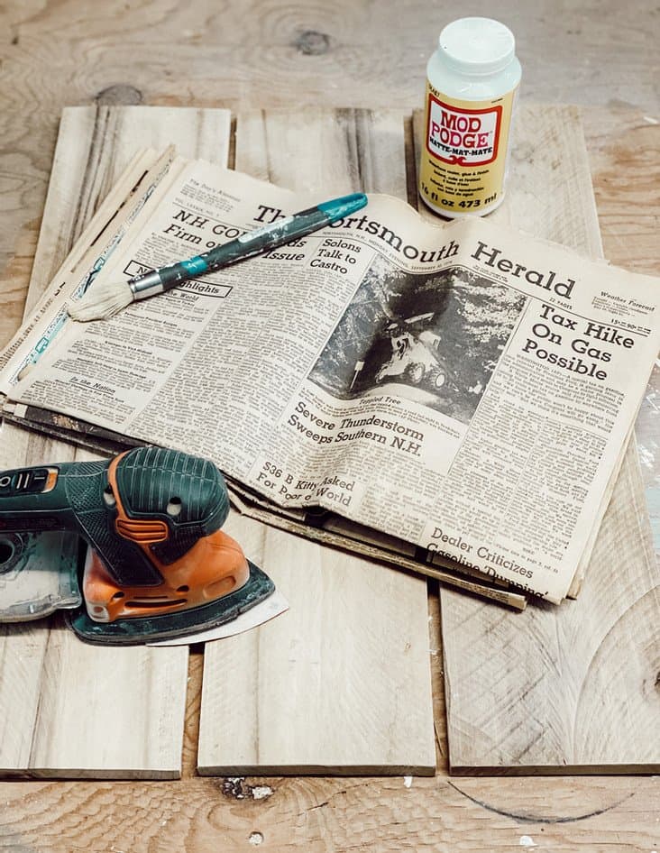 Old Newspaper, wood, and sander.