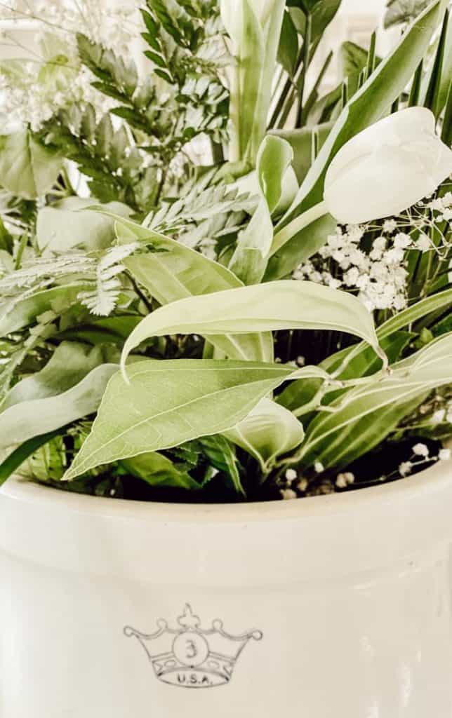 Vintage Crocks with greenery and white tulips for florist style vintage crock flower arrangements.