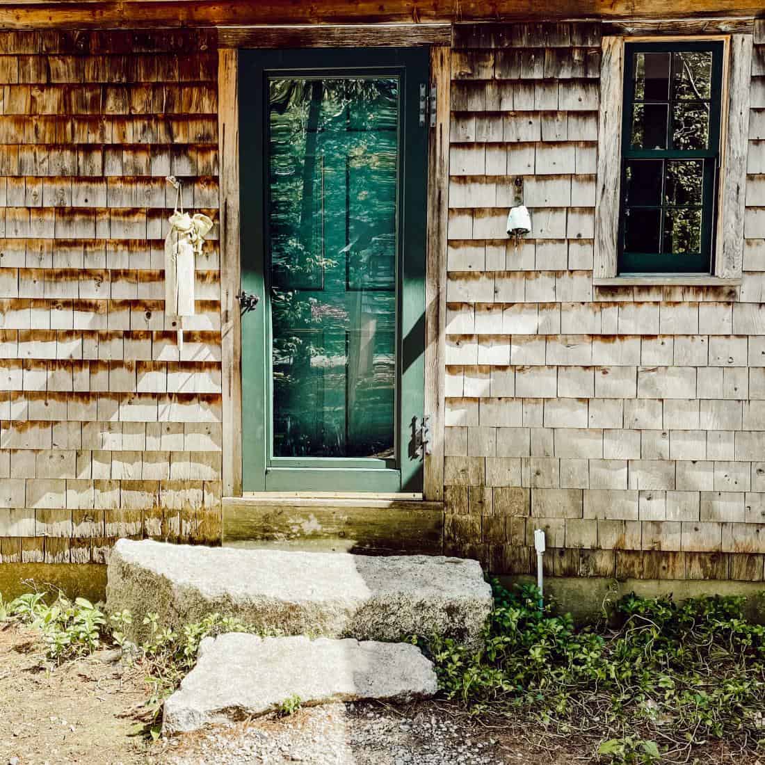 weathered cedar shake siding on old coastal Maine home and front door.