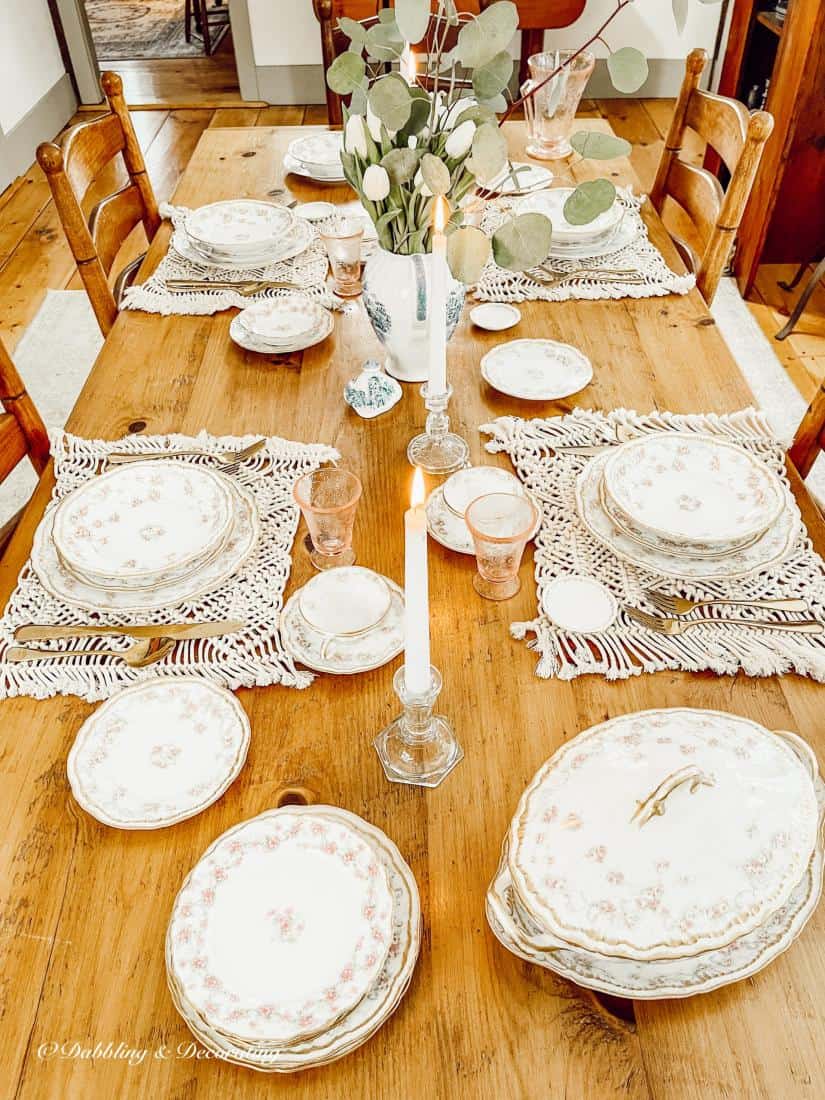 A wooden table topped with plates of food on a plate