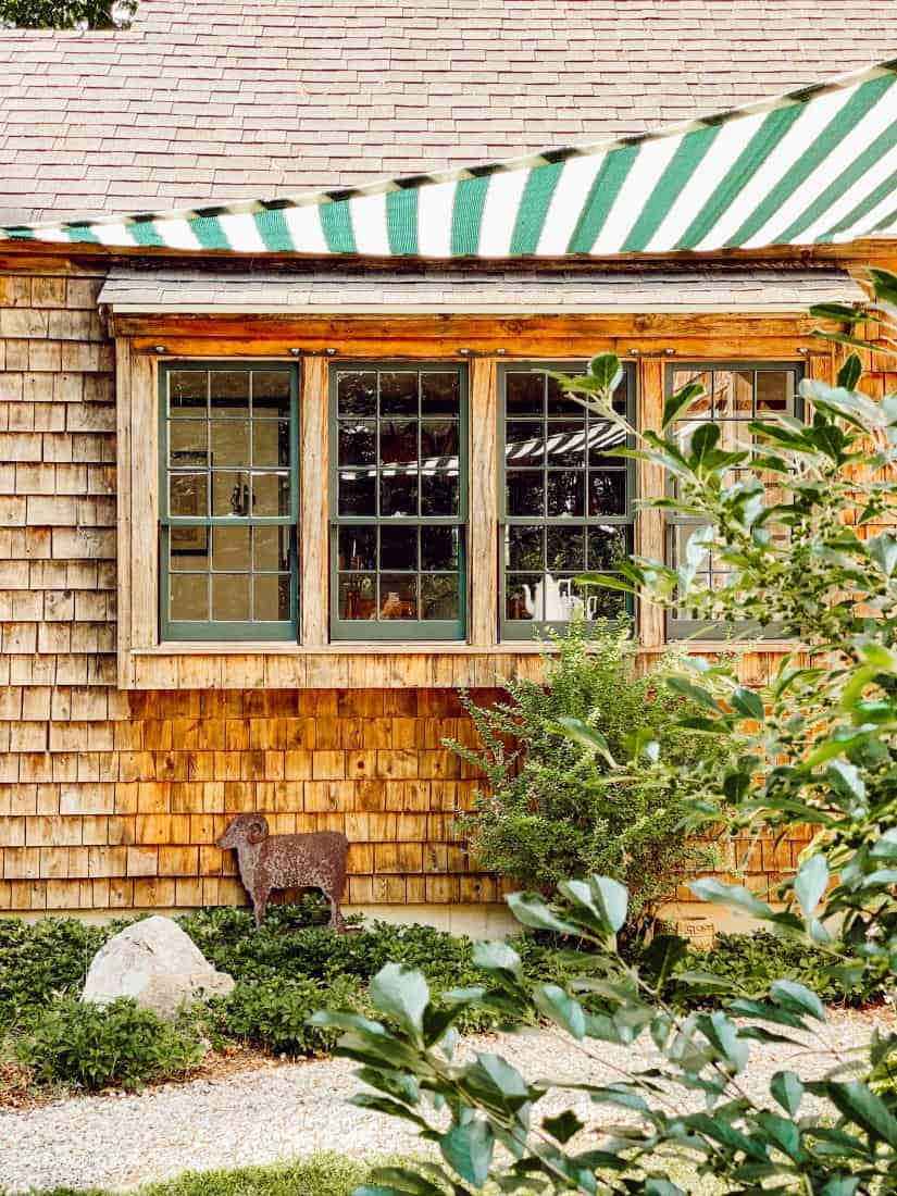 Cedar shake siding and four windows outside view.