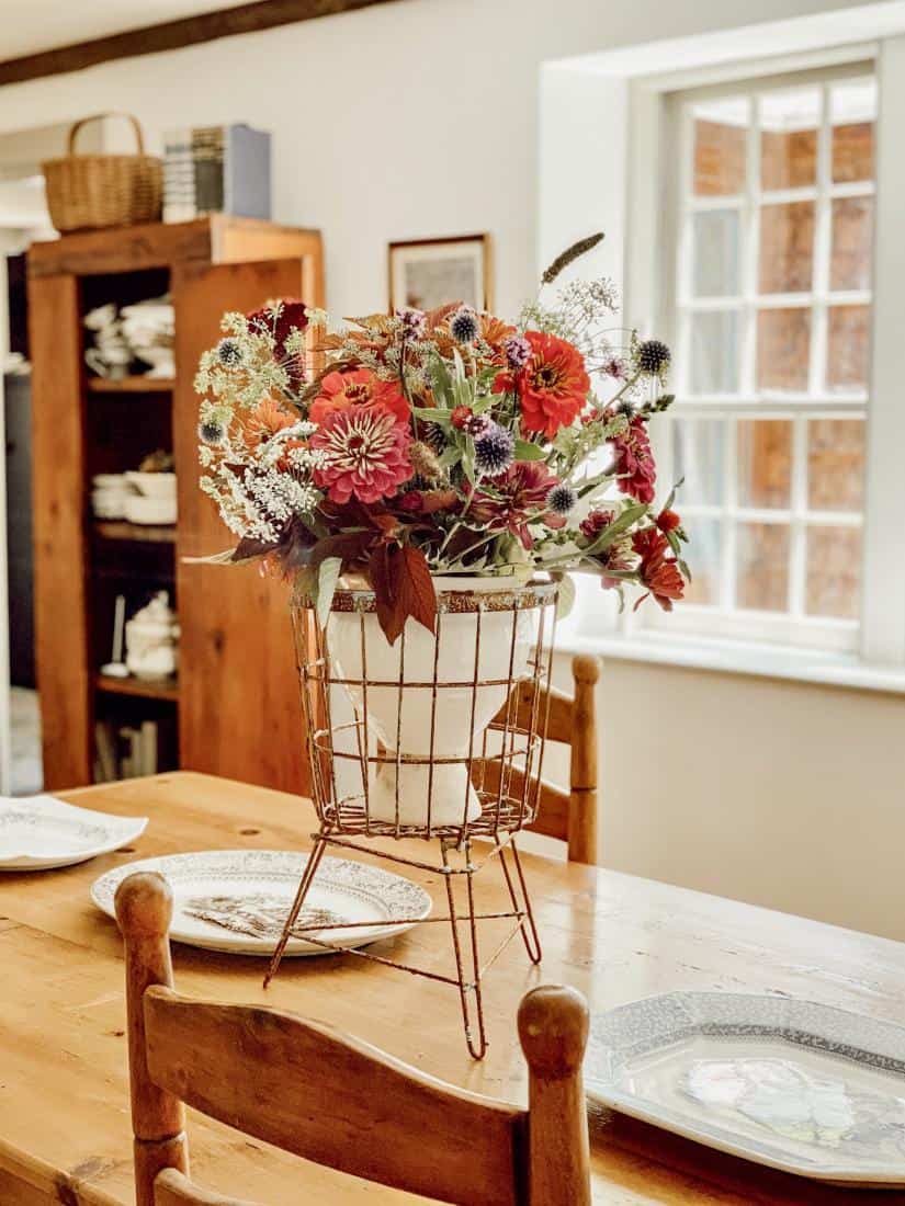 A living room filled with furniture and vase of flowers on a table