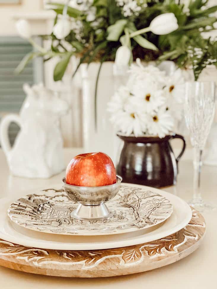 Vintage Crocks and jugs with place setting on table.