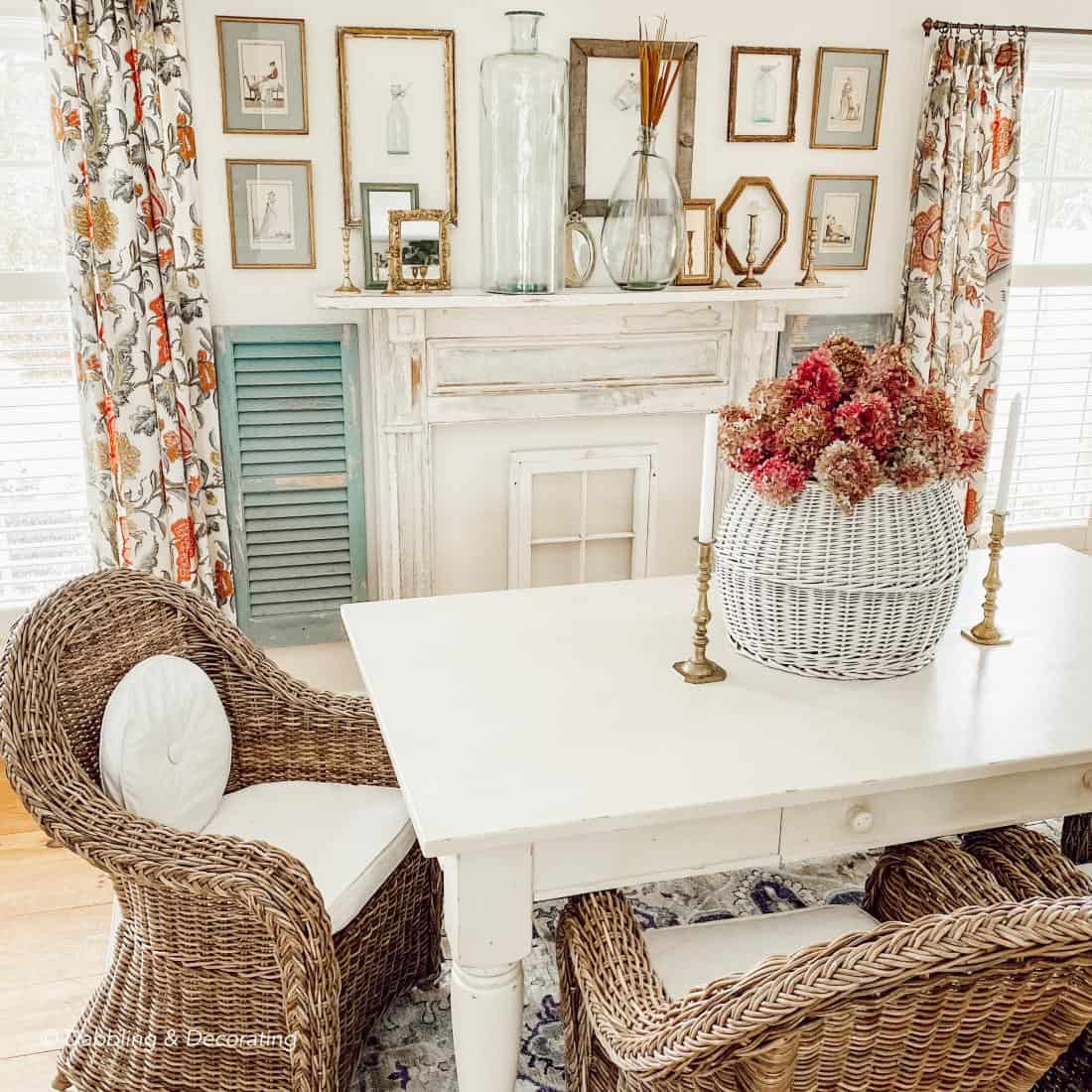 Dining Room and table with vintage gold frames and bottle wall display over mantel.