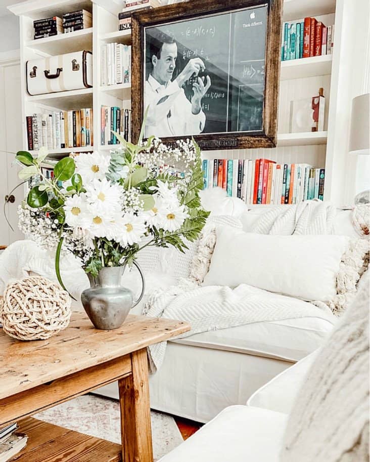 Small Home Library with bouquet of flowers on coffee table.