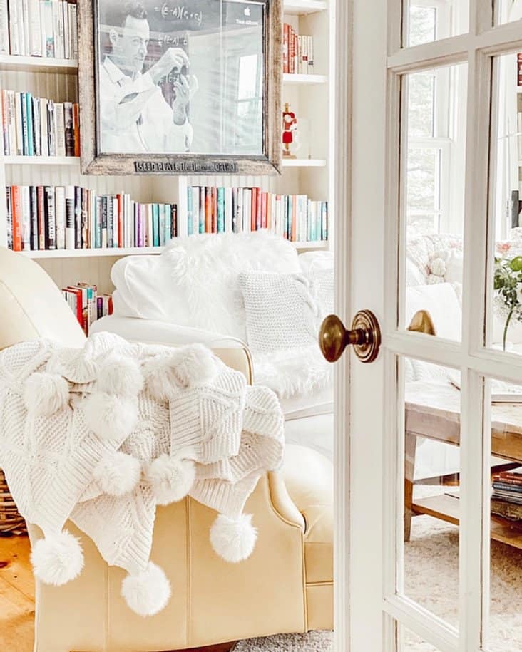 White glass door entering into a small home library.