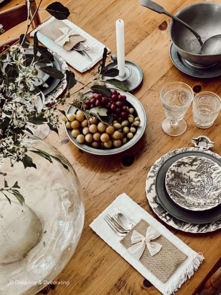 A wooden table topped with plates of food on a plate