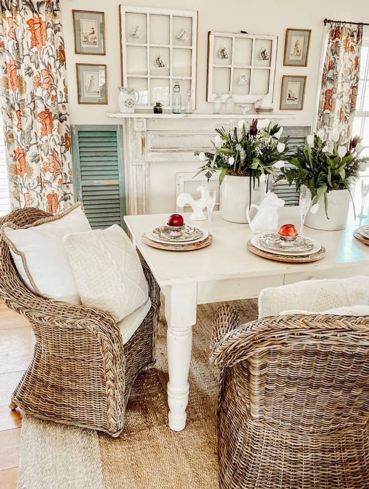 Vintage crocks spring floral arrangements on white farmhouse table in dining room.