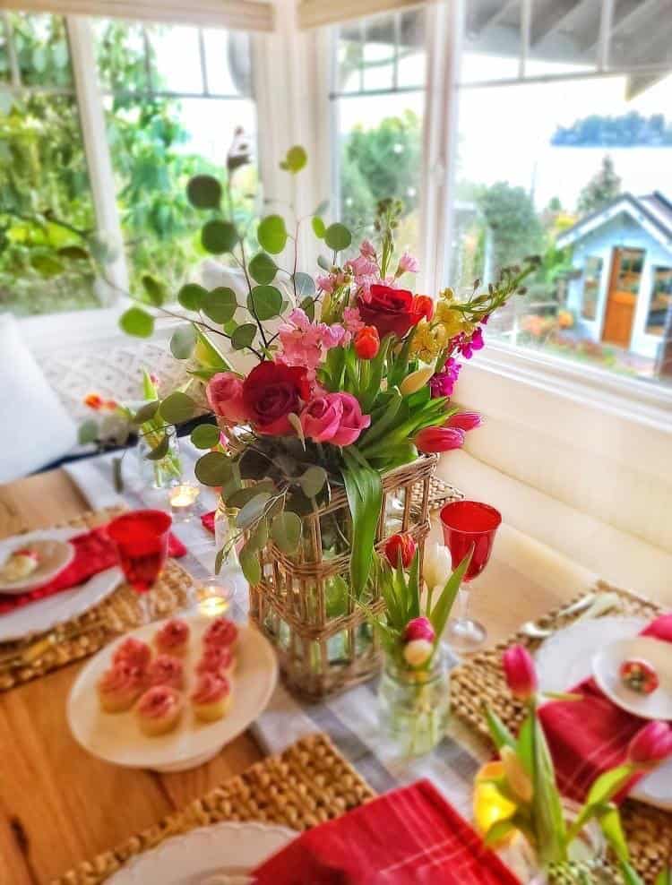 Thrifty Valentine's Day table decor featuring red and white flowers.