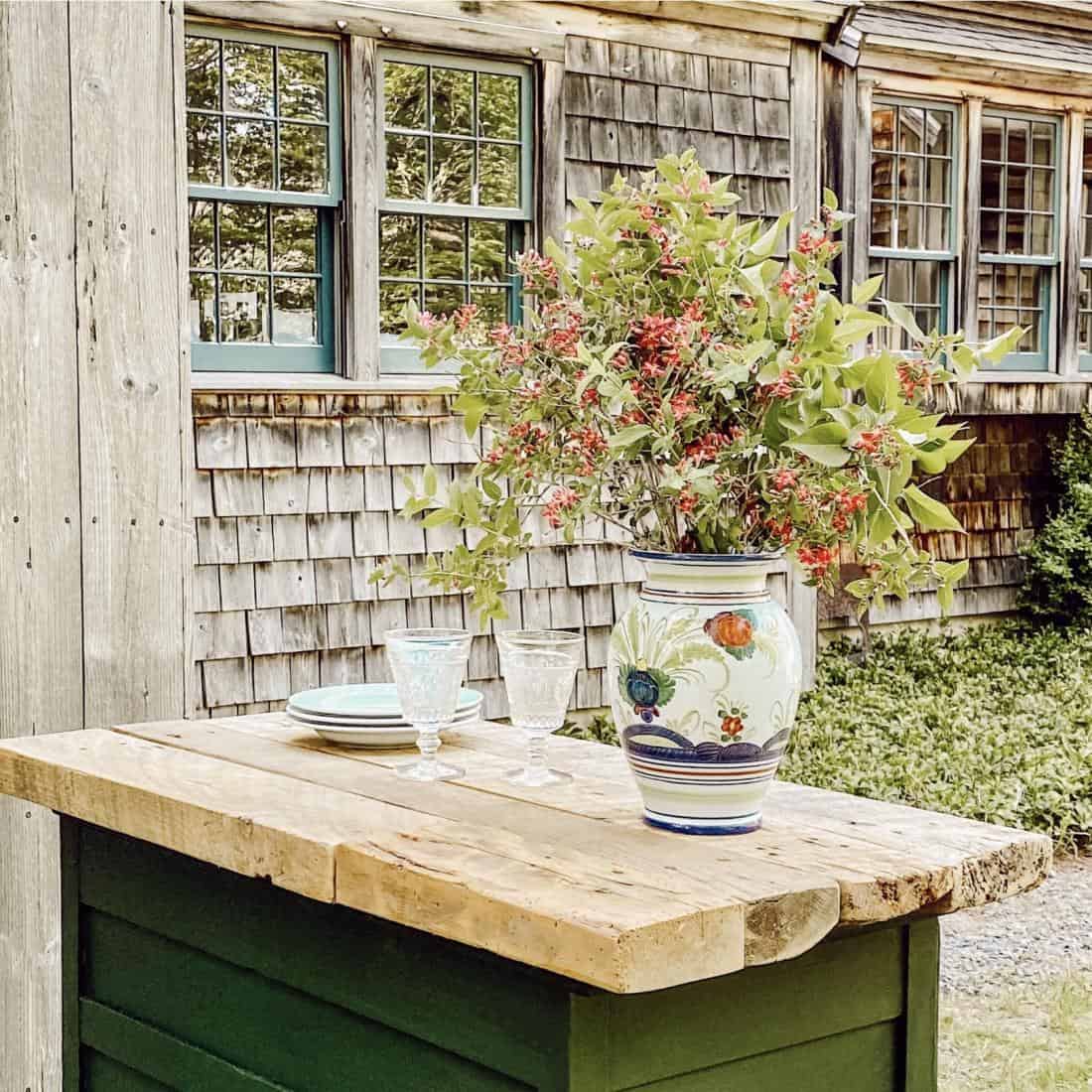 Weathered cedar shake siding home with outdoor grilling station.