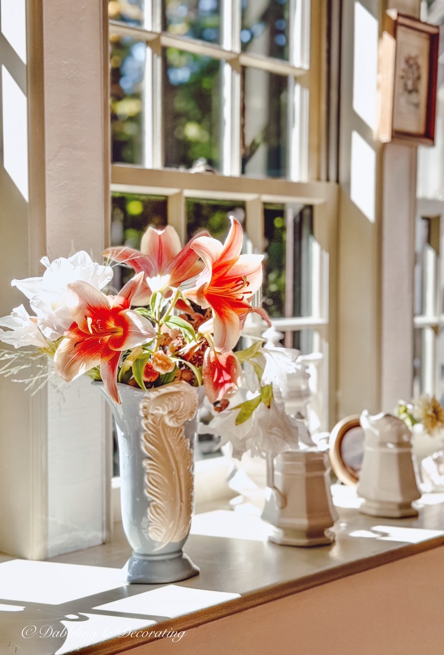 Window sill decor ideas with vintage flower arrangements, cozy, warm, and stylish.