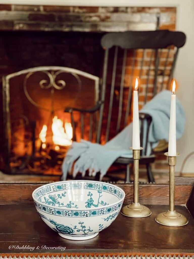 Vintage blue and white bowl on coffee table in front of fireplace.