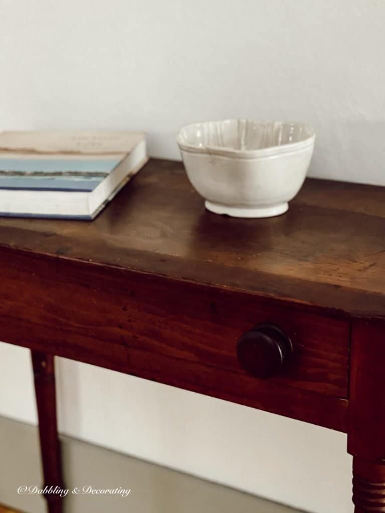 Vintage Ironstone mold and book on antique table.