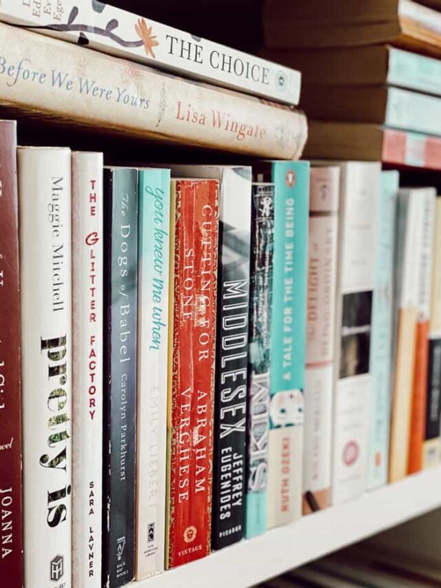 Stack of old books horizontal and vertically layered on bookshelf.