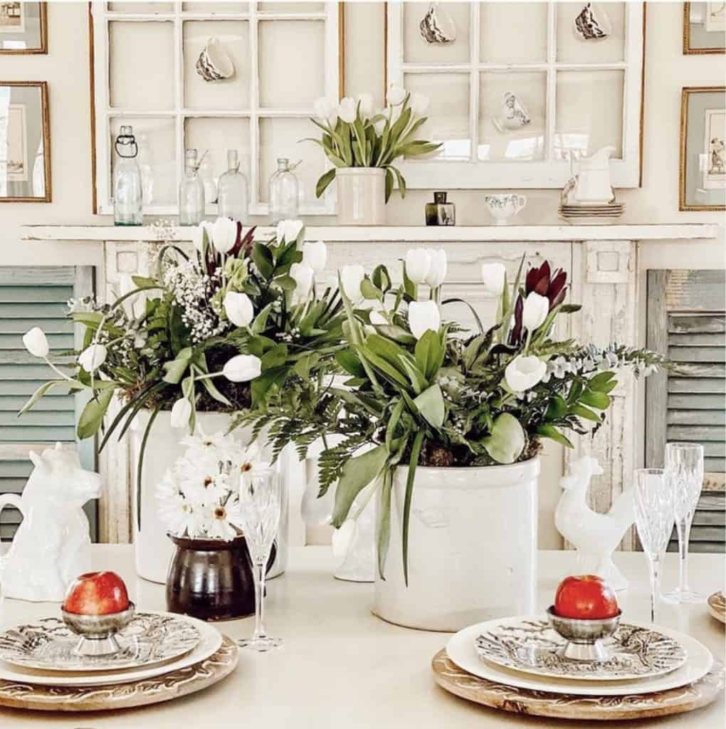 Hanging vintage teacups on old windows over faux mantel.