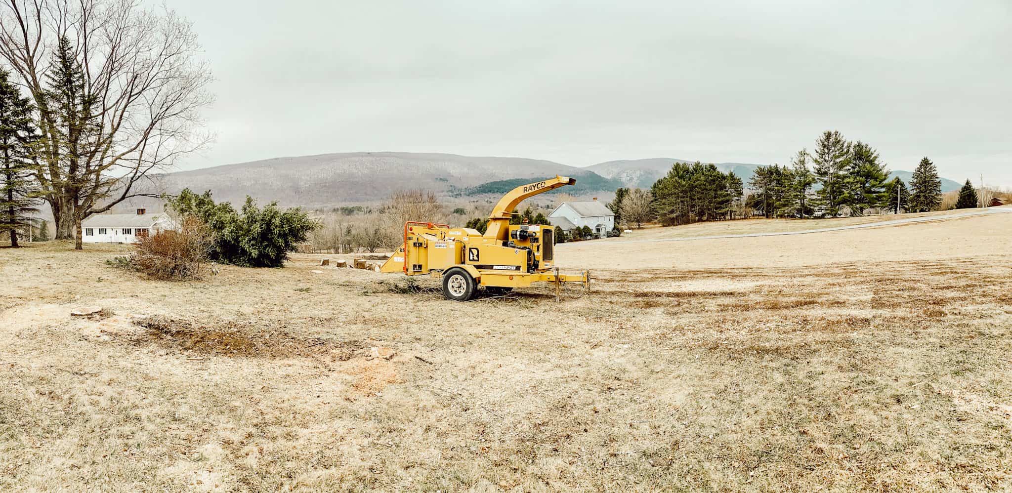 A truck is parked on the side of a dirt field