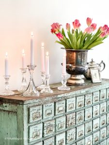 A chippy green apothecary cabinet
