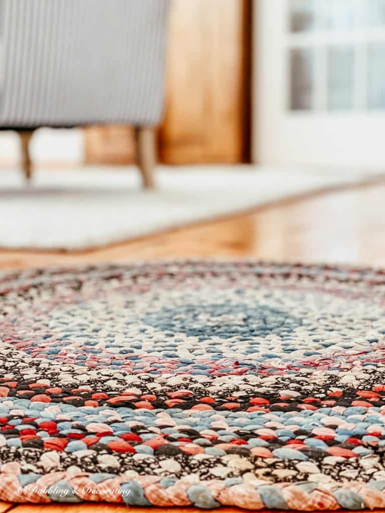 A close up of a colorful braided rug