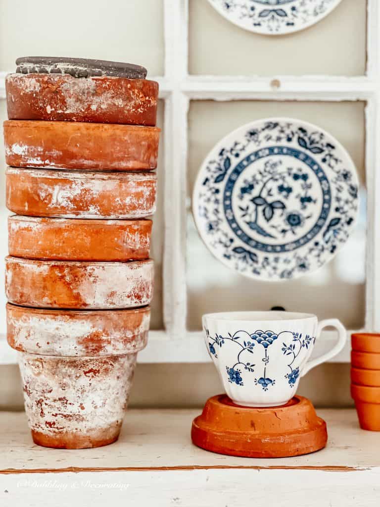 Terracotta pots and a teacup,