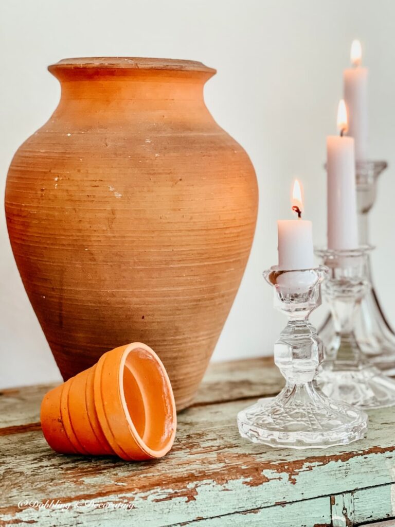 Large Terracotta Pot Indoors with Glass Candlesticks