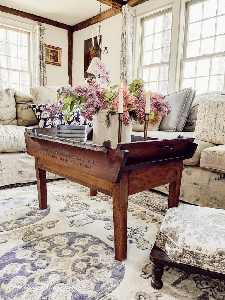 Antique coffee table decorated with lilac.